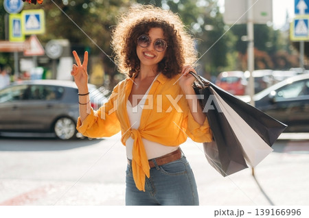 On the way to sales, walk. Happy woman is with shopping bags in town 139166996