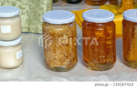 Royal jelly honey comb and other bee products in glass jars 139167428