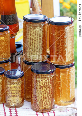 Organic honeycomb in jars on market 139167624