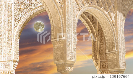 Arches in Islamic (Moorish) style (against the sunset with the super moon) in Alhambra, Granada, Spain        139167664