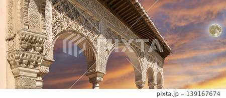 Arches in Islamic (Moorish) style (against the sunset with the super moon) in Alhambra, Granada, Spain Arches in Islamic (Moorish) style (against the sunset with the super moon) in Alhambra, Granada, Spain 139167674