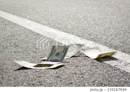 Dollar bills on asphalt road 139167694