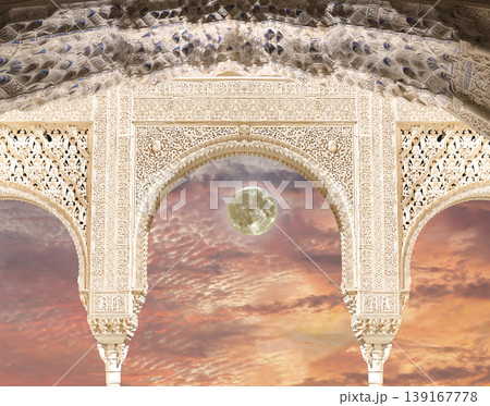 Arches in Islamic (Moorish) style (against the sunset with the super moon) in Alhambra, Granada, Spain Arches in Islamic (Moorish) style (against the sunset with the super moon) in Alhambra, Granada, Spain 139167778