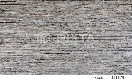 Close-up of rough wooden board texture with weathered layered surface and natural grain. Close-up of rough wooden board texture with weathered layered surface and natural grain. 139167933