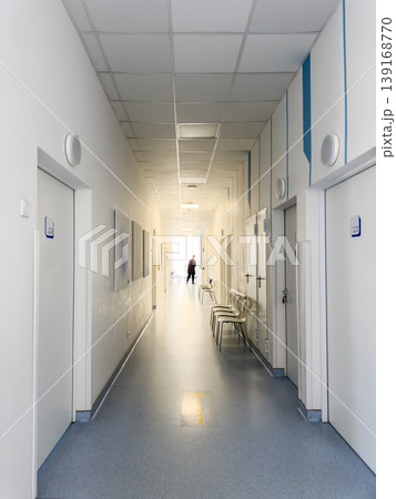 Bright hospital corridor hallway in modern clinic with medical doors, chairs and treatment rooms. Clean healthcare interior for diagnosis, consultation, doctor visits and patient care. 139168770