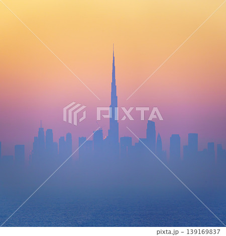 Dubai, United Arab Emirates - Jan 12 2024, Panoramic view of downtown Dubai skyscrapers, with Burj Khalifa in the middle, at dawn in a haze, a view from the sea, Dubai, United Arab Emirates  139169837