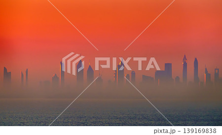 Dubai, United Arab Emirates - Jan 12 2024, Panoramic view of downtown Dubai skyscrapers, with Burj Khalifa in the middle, at dawn in a haze, a view from the sea, Dubai, United Arab Emirates  139169838