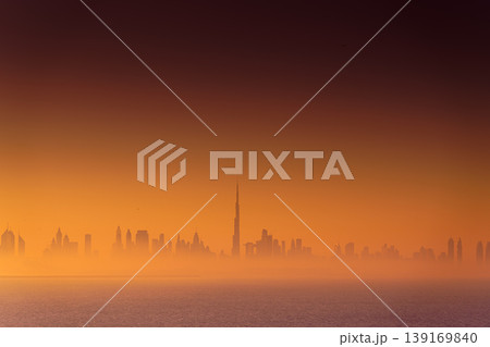 Dubai, United Arab Emirates - Jan 12 2024, Panoramic view of downtown Dubai skyscrapers, with Burj Khalifa in the middle, at dawn in a haze, a view from the sea, Dubai, United Arab Emirates  139169840