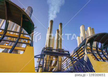 Dubai, United Arab Emirates - Jan 12 2024, Bottom-up view of the exhaust pipes with steam coming from them, MSC Virtuosa cruise ship, at daytime, Dubai, United Arab Emirates Dubai, United Arab Emirates - Jan 12 2024, Bottom-up view of the exhaust pipes with steam coming from them, MSC Virtuosa cruise ship, at daytime, Dubai, United Arab Emirates 139169851