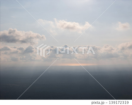 Sky with clouds above distant land during bright day light Sky with clouds above distant land during bright day light 139172319