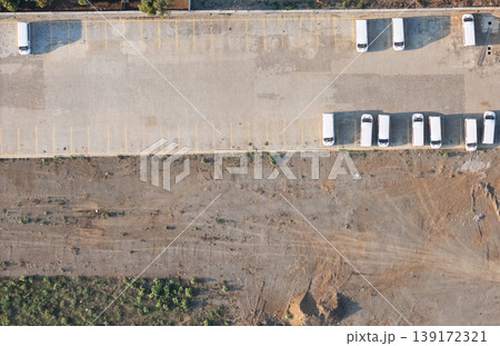 Several parked vehicles at a location with empty ground space 139172321