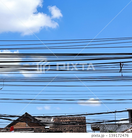 photo of electrical cable installation hanging above with blue sky background photo of electrical cable installation hanging above with blue sky background 139172476