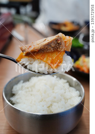 A Spoonful of Steamed White Rice Topped with Sizzling Korean Kimchi Stew A Spoonful of Steamed White Rice Topped with Sizzling Korean Kimchi Stew 139172958