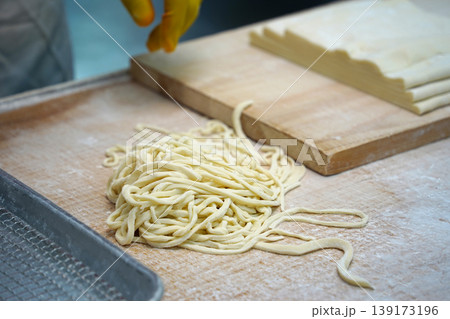 Traditional Korean Hand-cut Noodles Preparation on a Wooden Cutting Board, Kalguksu 139173196