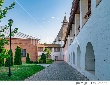 Astrakhan Kremlin inner grounds in Russia displaying historical white walls, cobblestone path, and a towering structure on a clear day Astrakhan Kremlin inner grounds in Russia displaying historical white walls, cobblestone path, and a towering structure on a clear day 139173566