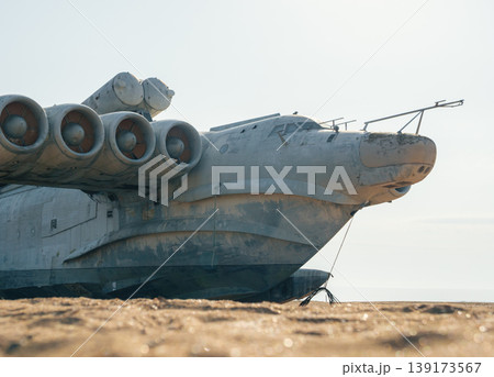 Abandoned Lun-class ekranoplan on a deserted beach near the Caspian Sea under a clear blue sky 139173567