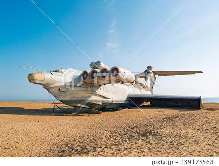 Abandoned Lun-class ekranoplan on a deserted beach near the Caspian Sea under a clear blue sky Abandoned Lun-class ekranoplan on a deserted beach near the Caspian Sea under a clear blue sky 139173568