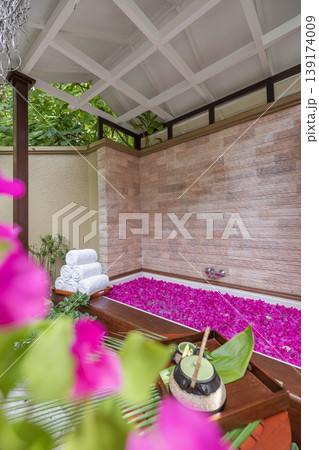 Wellness retreat serene atmosphere elegant treatment room tropical spa interior flowers bathtub with pink flowers relaxing design luxury hotel resort care peaceful floral decoration beauty Wellness retreat serene atmosphere elegant treatment room tropical spa interior flowers bathtub with pink flowers relaxing design luxury hotel resort care peaceful floral decoration beauty 139174009
