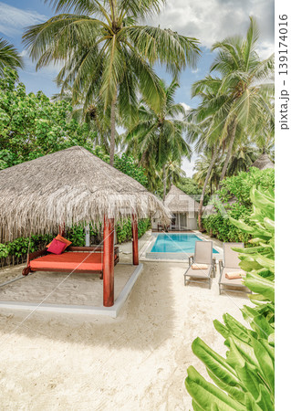 Tranquil tropical beach resort private pool palm trees sandy scenic canopy exotic travel destination summer tourism background peaceful poolside paradise luxury coastal retreat water horizon 139174016