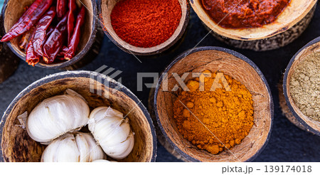 Fantastic top view indian spices colorful ingredients in wooden bowls aromatic masala turmeric chili curry powder coriander peppercorn culinary background organic healthy food composition Fantastic top view indian spices colorful ingredients in wooden bowls aromatic masala turmeric chili curry powder coriander peppercorn culinary background organic healthy food composition 139174018