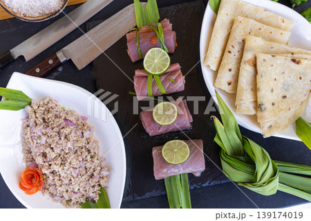 Professional gourmet kitchen cutting board raw fish prepared fillet ingredients knife spices lemon herbs healthy seafood cooking background culinary preparation aromatic food composition Professional gourmet kitchen cutting board raw fish prepared fillet ingredients knife spices lemon herbs healthy seafood cooking background culinary preparation aromatic food composition 139174019