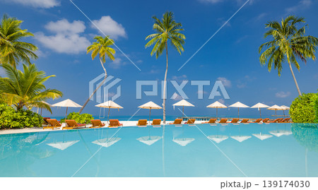 Luxury resort swimming pool with sunbeds and umbrellas under palm trees perfect summer travel reflection artistic tourism background tropical vacation leisure scene high end holiday destination Luxury resort swimming pool with sunbeds and umbrellas under palm trees perfect summer travel reflection artistic tourism background tropical vacation leisure scene high end holiday destination 139174030