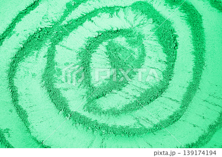 concentric bands drawn on the green powder 139174194