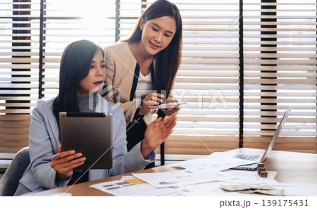 Two women collaborate in a bright, modern office 139175431