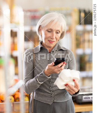 Elderly woman scanning qr code for yogurt 139175725