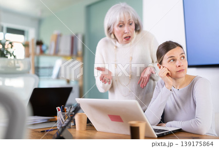 Mature female manager is dissatisfied with the work of an employee - she yells and reproaches her Mature female manager is dissatisfied with the work of an employee - she yells and reproaches her 139175864