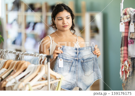Girl at trading floor pick out and buying shorts 139176175