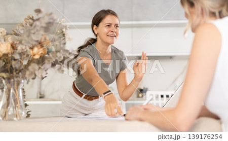 Young girl communicating with partner in the kitchen 139176254