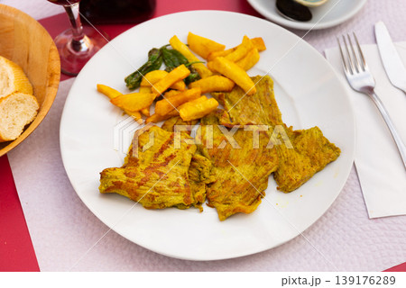 Pork secret served with potatoes and peppers 139176289