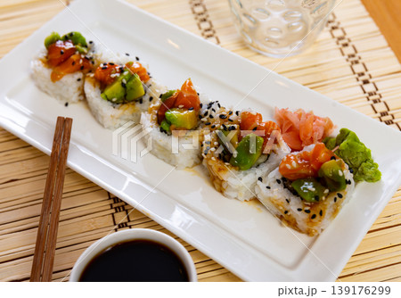 Sushi rolls with crab, cucumber, salmon, avocado seasoned with unagi sauce Sushi rolls with crab, cucumber, salmon, avocado seasoned with unagi sauce 139176299
