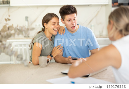 Married couple clients listen attentively and intently to woman of seller 139176338