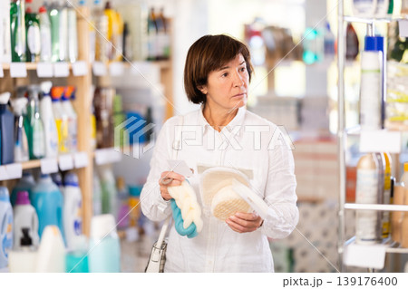 Elderly woman choosing body washcloth in store 139176400