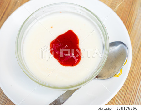 Creamy panna cotta with cranberry jam in glass bowl Creamy panna cotta with cranberry jam in glass bowl 139176566