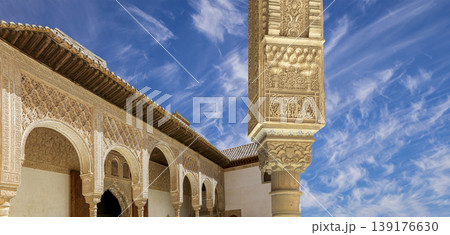 Arches in Islamic (Moorish) style (against the background of a beautiful sky with clouds) in Alhambra, Granada, Spain Arches in Islamic (Moorish) style (against the background of a beautiful sky with clouds) in Alhambra, Granada, Spain 139176630