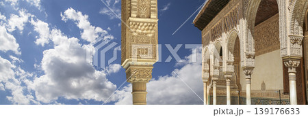 Arches in Islamic (Moorish) style (against the background of a beautiful sky with clouds) in Alhambra, Granada, Spain Arches in Islamic (Moorish) style (against the background of a beautiful sky with clouds) in Alhambra, Granada, Spain 139176633