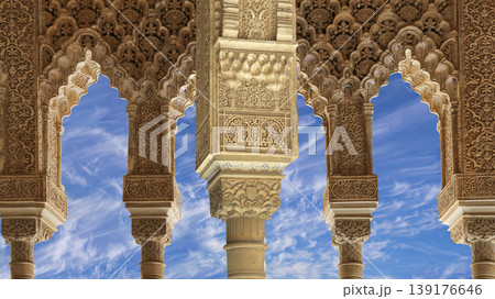 Arches in Islamic (Moorish) style (against the background of a beautiful sky with clouds) in Alhambra, Granada, Spain Arches in Islamic (Moorish) style (against the background of a beautiful sky with clouds) in Alhambra, Granada, Spain 139176646