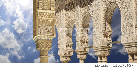 Arches in Islamic (Moorish) style (against the background of a beautiful sky with clouds) in Alhambra, Granada, Spain Arches in Islamic (Moorish) style (against the background of a beautiful sky with clouds) in Alhambra, Granada, Spain 139176657