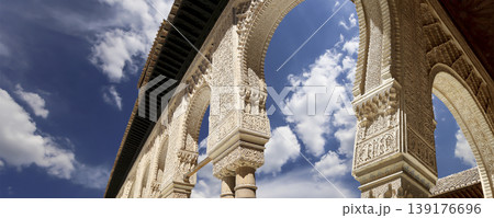 Arches in Islamic (Moorish) style (against the background of a beautiful sky with clouds) in Alhambra, Granada, Spain 139176696