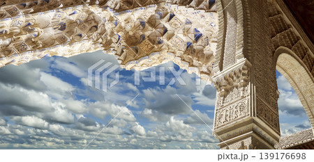 Arches in Islamic (Moorish) style (against the background of a beautiful sky with clouds) in Alhambra, Granada, Spain Arches in Islamic (Moorish) style (against the background of a beautiful sky with clouds) in Alhambra, Granada, Spain 139176698
