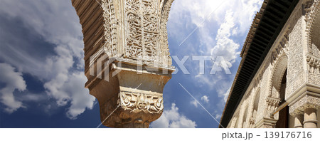 Arches in Islamic (Moorish) style (against the background of a beautiful sky with clouds) in Alhambra, Granada, Spain 139176716