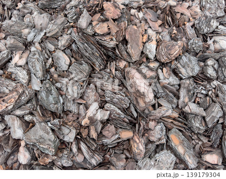 Closeup top view of bark mulch wood texture background made of natural brown tree chips. Rustic organic surface for garden design, landscaping, eco backdrop, material pattern and earthy wallpaper. Closeup top view of bark mulch wood texture background made of natural brown tree chips. Rustic organic surface for garden design, landscaping, eco backdrop, material pattern and earthy wallpaper. 139179304