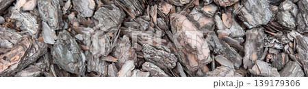 Closeup top view of bark mulch wood texture background made of natural brown tree chips. Rustic organic surface for garden design, landscaping, eco backdrop, material pattern and earthy wallpaper. Closeup top view of bark mulch wood texture background made of natural brown tree chips. Rustic organic surface for garden design, landscaping, eco backdrop, material pattern and earthy wallpaper. 139179306