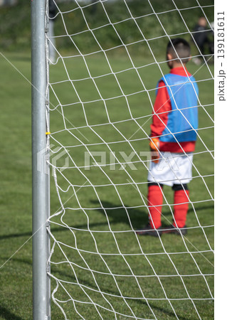 Close-up of soccer goals on an outdoor soccer field, the team of soccer players is blurred. 139181611