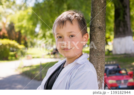 Happy child boy in park outdoors Happy child boy in park outdoors 139182944