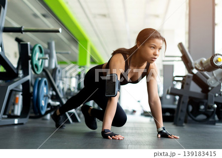 Young Black woman in low crawl position on gym floor Young Black woman in low crawl position on gym floor 139183415