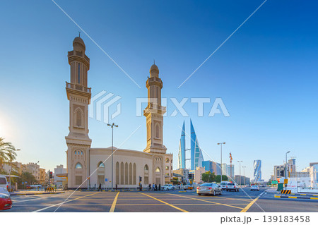Manama, Bahrain - Jan 08 2024, Close up view of Ras Rumman Mosque, with the World trade center if Bahrain behind it, at daytime, Manama, Bahrain Manama, Bahrain - Jan 08 2024, Close up view of Ras Rumman Mosque, with the World trade center if Bahrain behind it, at daytime, Manama, Bahrain 139183458
